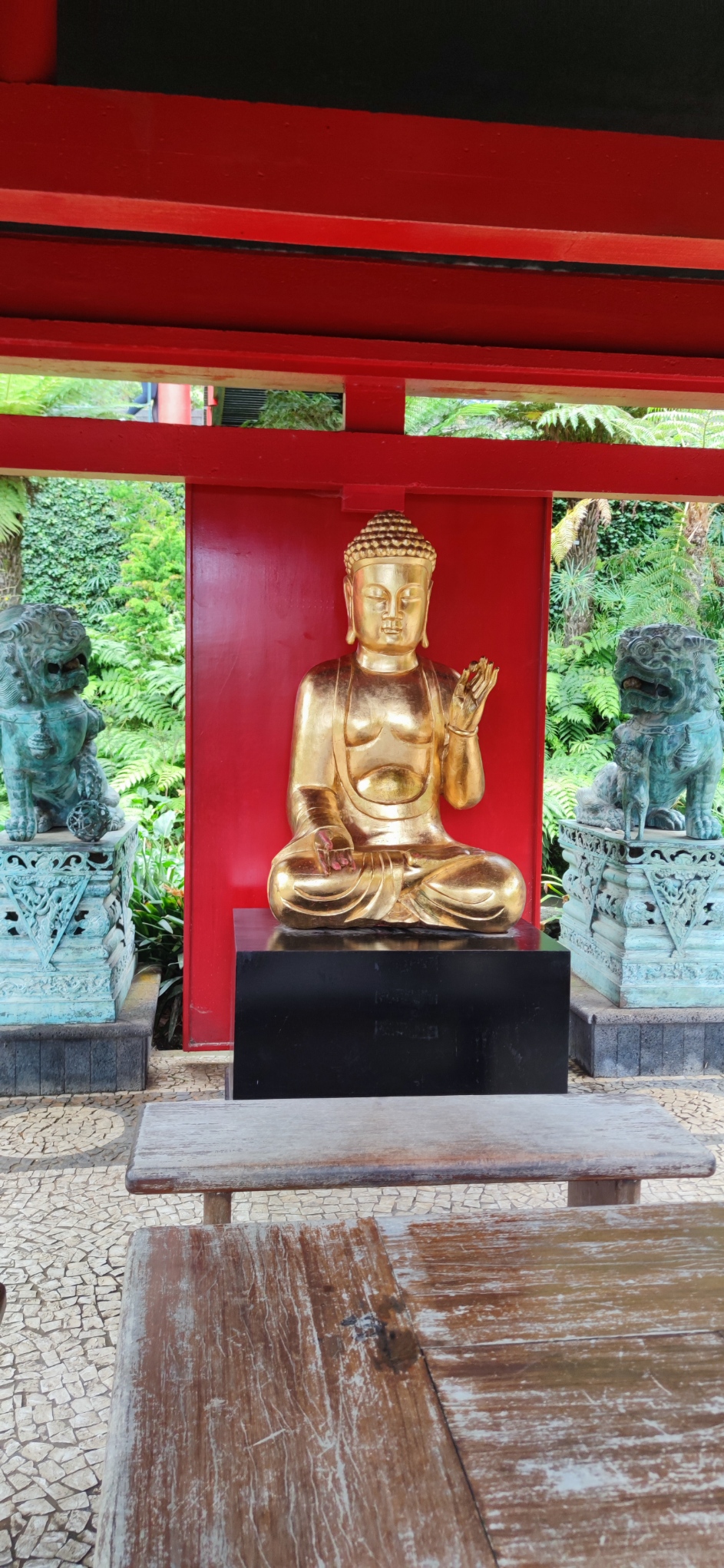 Golden Buddha statue in a red shrine